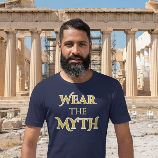 Man wearing a navy blue t-shirt with 'WEAR THE MYTH' text in front of ancient ruins.