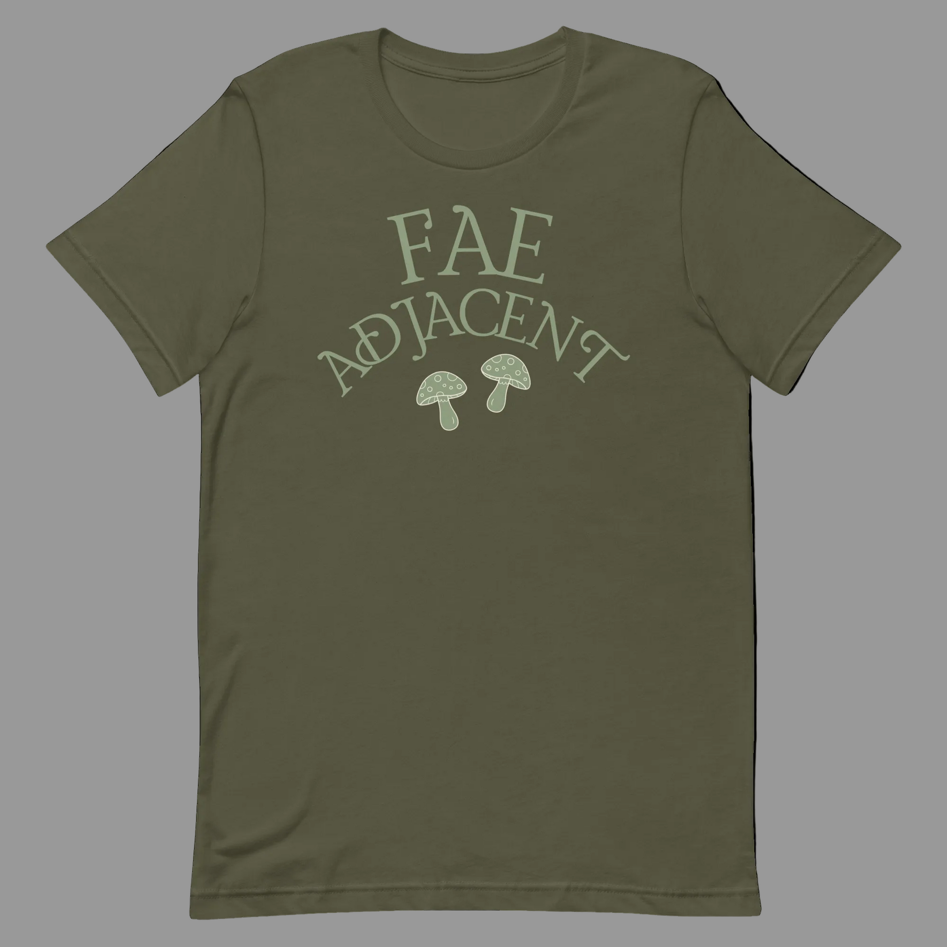 An olive green short-sleeve t-shirt with a light sage green graphic on the chest that reads 'FAE ADJACENT' above two small mushrooms, shown on a plain white background.