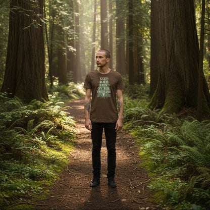 man wearing keep your eyes on the treeline tee