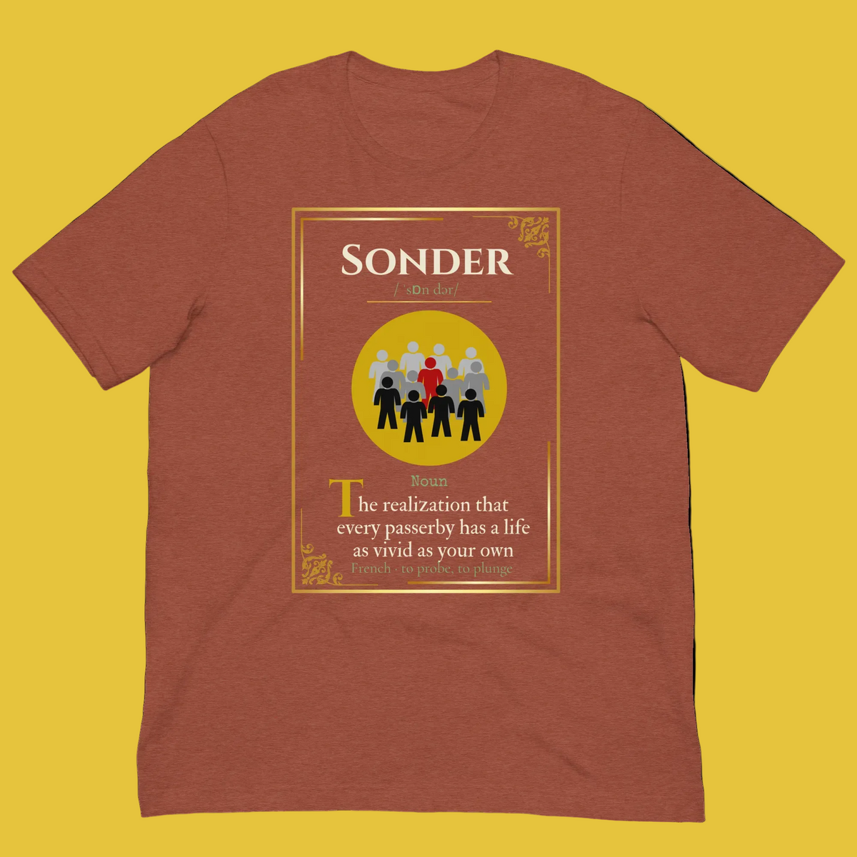 A heathered rust-brown short-sleeve t-shirt with a graphic print on the front. The graphic features a yellow border and a central yellow circle containing black and red figures, with the word 'SONDER' at the top and a definition of the word printed below.