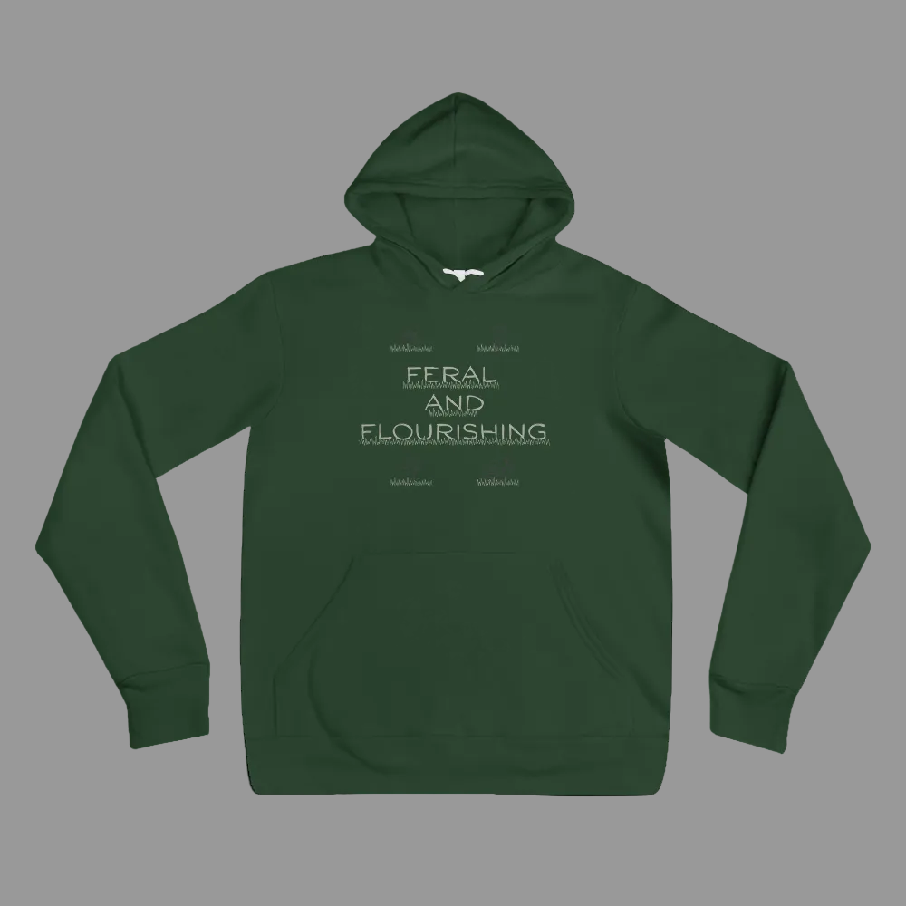 A dark green pullover hoodie with a front kangaroo pocket and a light gray graphic text print reading 'FERAL AND FLOURISHING' on the chest, displayed against a solid white background.