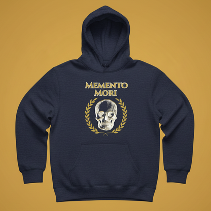 A navy blue pullover hoodie with a front graphic featuring the text 'MEMENTO MORI' in gold, a white skull, and a gold laurel wreath, displayed against a solid mustard yellow background.