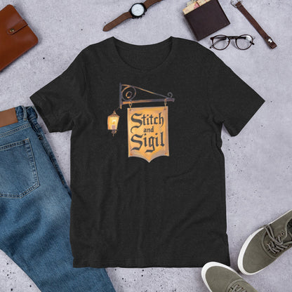 Stitch and Sigil logo graphic tee — brand tavern sign design on black heather — Stitch and Sigil