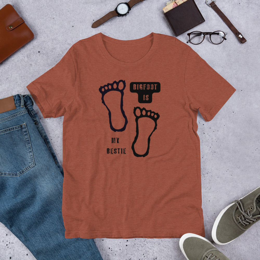 Bigfoot Is My Bestie cryptid graphic tee — Bigfoot and footprints design on heather clay — Stitch and Sigil