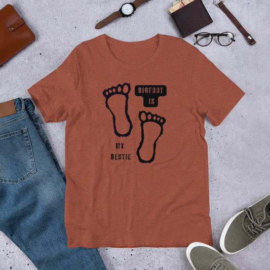 Bigfoot Is My Bestie cryptid graphic tee — Bigfoot and footprints design on heather clay — Stitch and Sigil