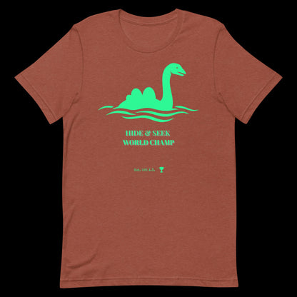 Nessie Hide and Seek World Champ cryptid graphic tee — Loch Ness Monster champion design on heather clay — Stitch and Sigil